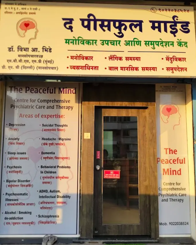The Peaceful Mind clinic entrance in Ravet with its signboard listing areas of expertise in English and Marathi